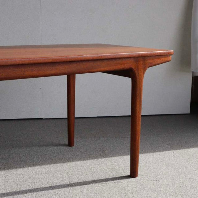 Mid-century vintage McIntosh teak coffee table with sleek tapered legs and smooth wood grain.