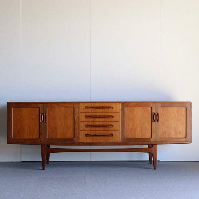 Mid-century British G-PLAN Fresco teak sideboard with rich wood grain, tapered legs, and symmetrical drawers and cabinets.