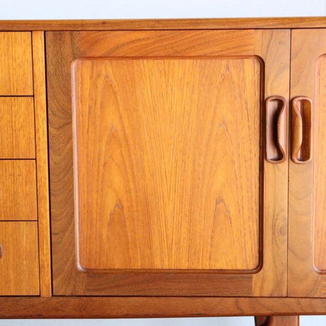 Mid-century British G-Plan Fresco sideboard in teak with smooth wood grain and rounded recessed cabinet doors.