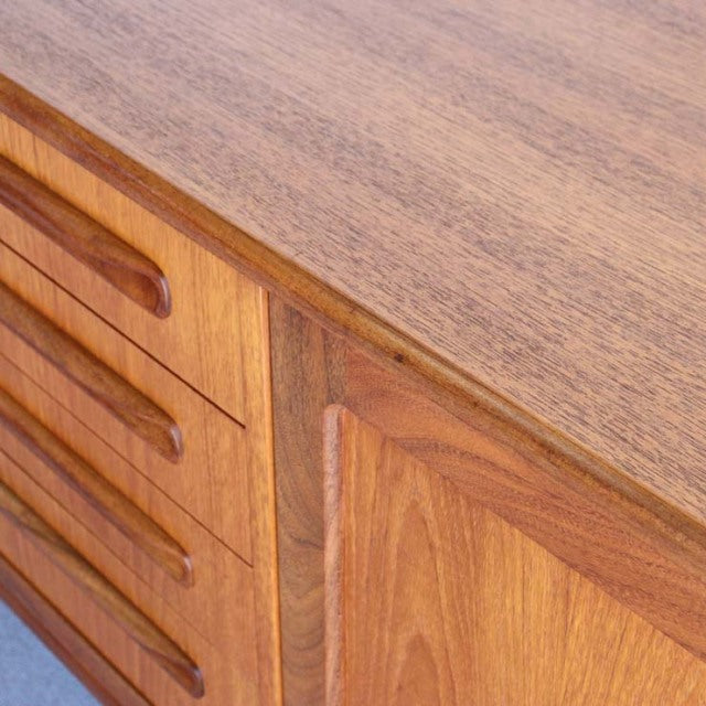 Mid-century British G-PLAN Fresco teak sideboard with smooth grain, rounded edges, and recessed handles.