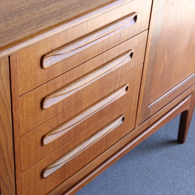 Vintage British G-Plan teak sideboard with mid-century Danish-inspired clean lines, smooth wood grain, and tapered legs.