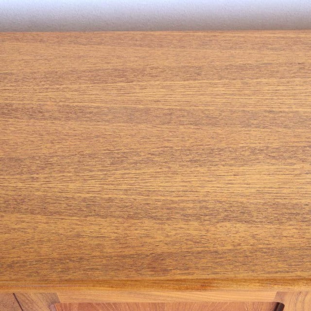 Mid-century British vintage teak sideboard top showcasing smooth wood grain with warm honey tones and subtle matte finish.