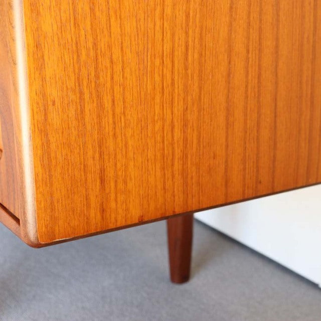 Mid-century British vintage teak sideboard corner showing rich wood grain and tapered leg by G-PLAN Denmark style.