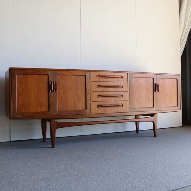Mid-century British G-PLAN Fresco teak sideboard with four doors, five central drawers, and tapered legs.