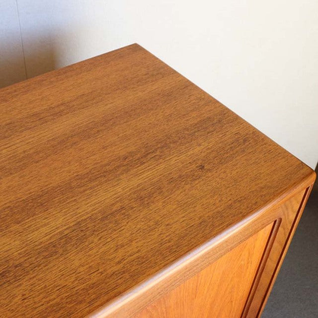 Close-up of vintage teak sideboard top with rich wood grain, smooth finish, and mid-century British design from G-PLAN.