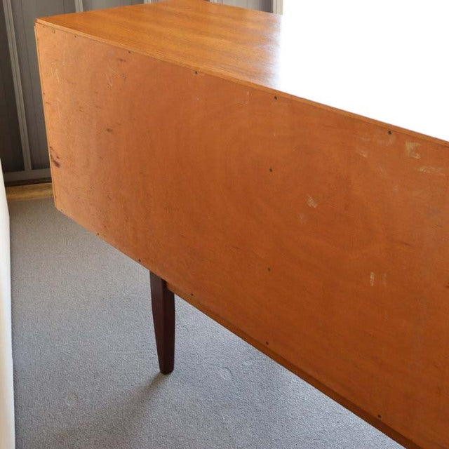 Vintage teak G-Plan mid-century British sideboard with sleek tapered legs and warm wood grain.