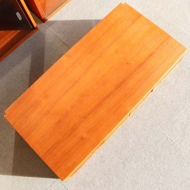 Vintage teak mid-century Danish cabinet top with smooth wood grain and warm honey tone.