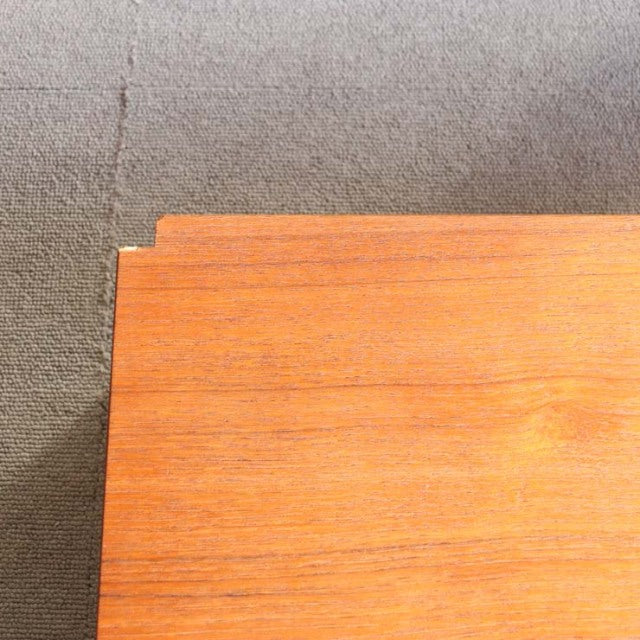 Close-up of vintage teak wood grain showcasing mid-century Danish craftsmanship from Randers Möbelfabrik, smooth surface.