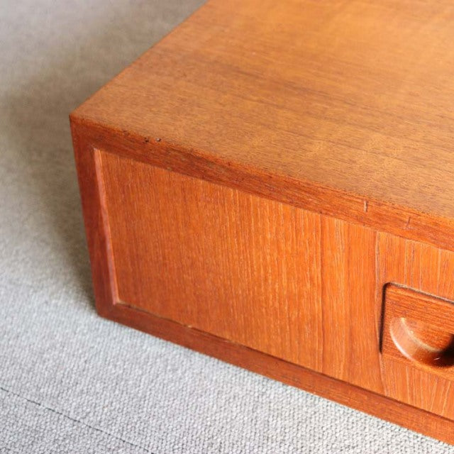 Mid-century vintage teak cabinet by Randers Møbelfabrik with smooth wood grain and recessed handle detail.