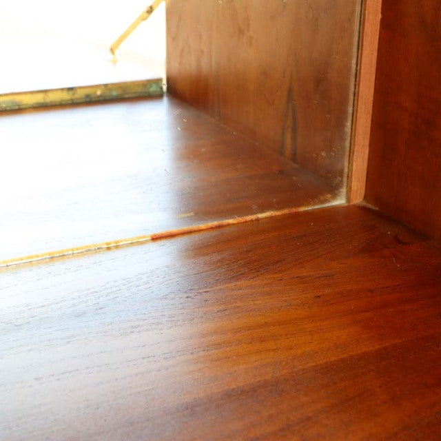 Close-up of vintage teak cabinet corner showing rich wood grain and smooth mid-century Danish craftsmanship by PS system.