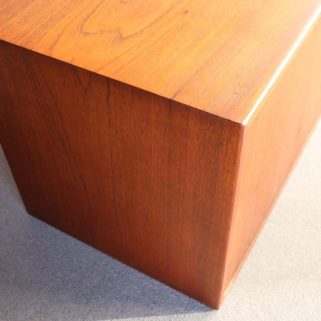 Vintage mid-century teak cabinet corner with rich wood grain and smooth finish, Danish design style.