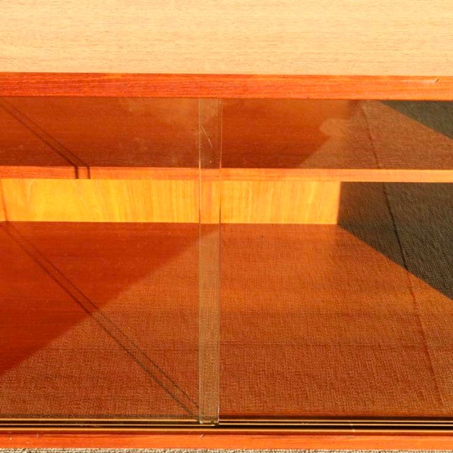 Mid-century vintage teak cabinet by Denmark's PS system, Preben Sørensen design, with glass sliding doors and visible wood.