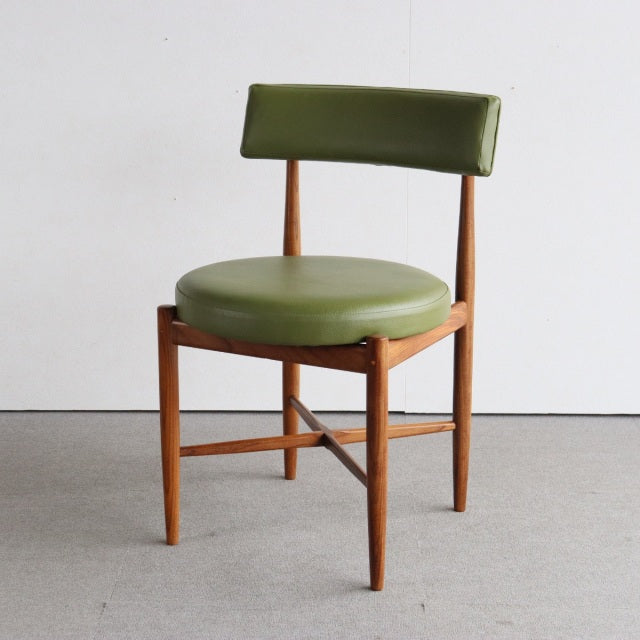 Mid-century British teak dining chair by G-PLAN with olive green round seat and backrest upholstery, slender tapered legs,.
