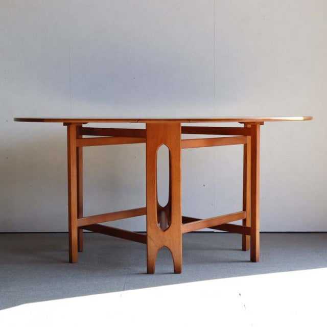 Vintage teak JENTIQUE drop-leaf table with mid-century British design, clean lines, and open oval cutout detail on sturdy.