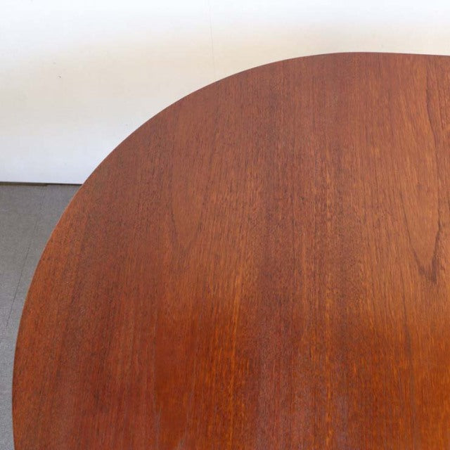 Mid-century vintage teak drop-leaf table with smooth grain and rounded edges, British-Denmark style.