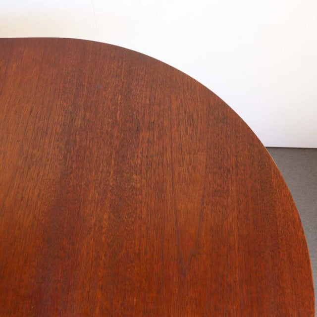 Vintage teak Jentique mid-century British drop-leaf table with rich wood grain and rounded edge.