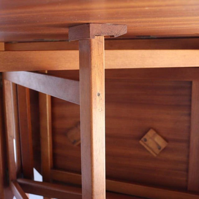 Close-up of mid-century vintage teak drop-leaf table leg and bracket with rich wood grain, British-Denmark design.