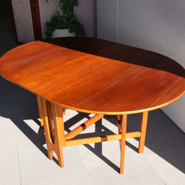 Mid-century British Jentique vintage teak drop-leaf table with warm wood grain and sturdy angled legs.