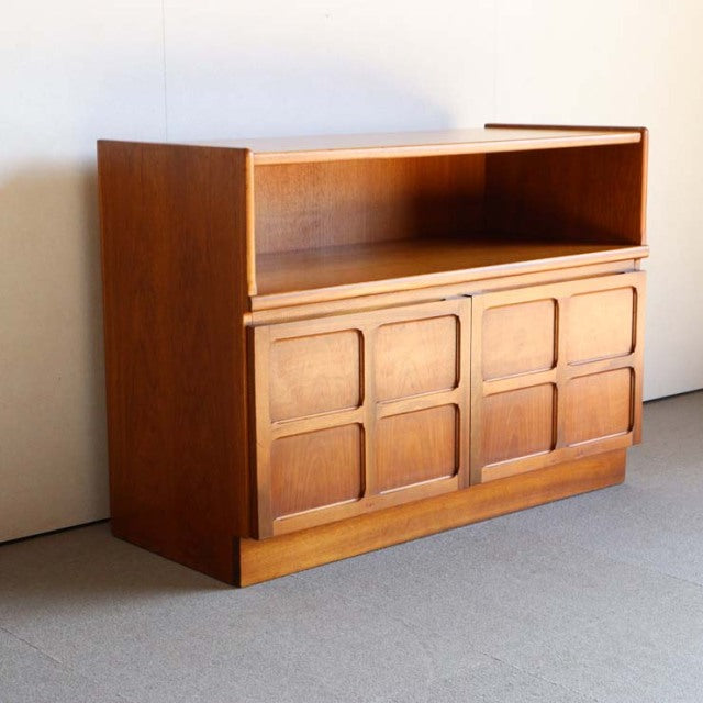 Mid-century British teak storage cabinet by Nathan with cross-design panels and open shelf, vintage Danish style with rich.