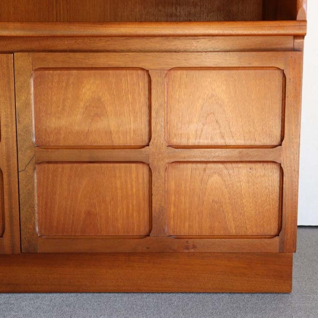 Vintage mid-century teak cabinet by British brand Nathan, featuring four recessed square panels with visible wood grain and.
