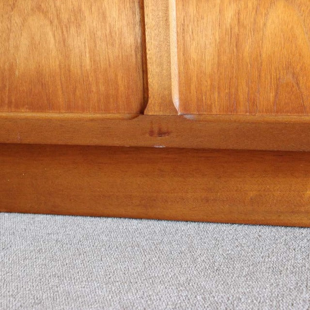 Close-up of vintage mid-century teak cabinet base showing warm wood grain and smooth finish from British brand Nathan.