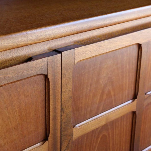 Close-up of vintage teak storage cabinet from British mid-century Nathan collection, showcasing rich wood grain and cross.