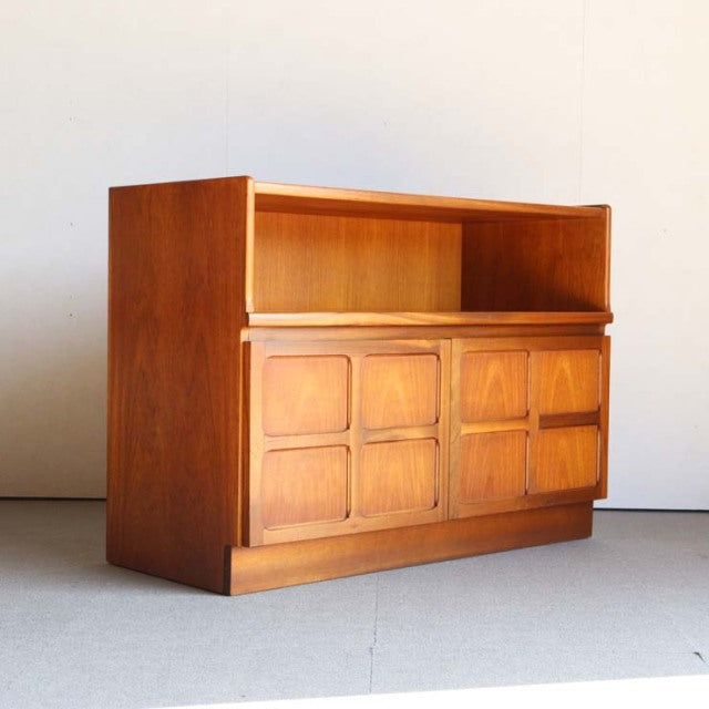 Vintage mid-century teak storage cabinet by Nathan featuring British-Denmark design influence, cross-patterned door fronts,.