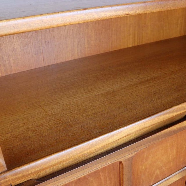 Close-up of vintage British teak storage cabinet interior showcasing smooth wood grain and mid-century craftsmanship from.