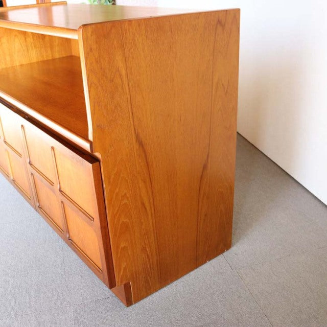 Mid-century British teak cabinet by NATHAN with distinct cross-patterned drawer fronts and rich wood grain.