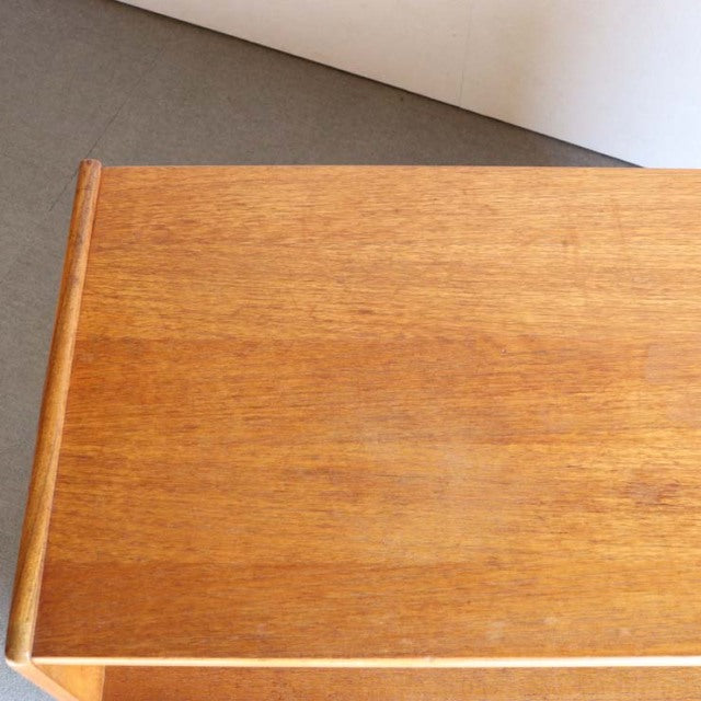 Mid-century British Nathan teak storage cabinet top showing warm wood grain and smooth finish.