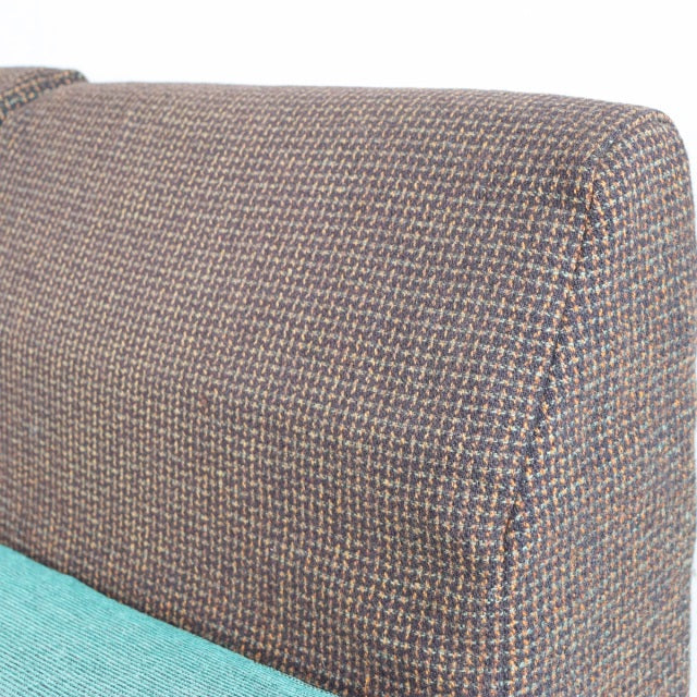 Vintage British mid-century teal and brown Harris Tweed sofa backrest with clean stitching and textured fabric upholstery.
