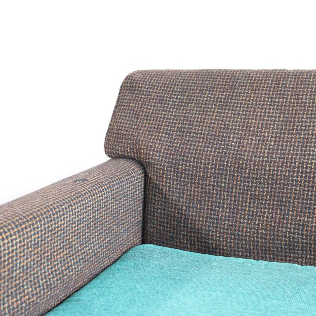 Vintage British mid-century two-seater sofa featuring teak frame with visible wood grain, Harris Tweed fabric upholstery in.