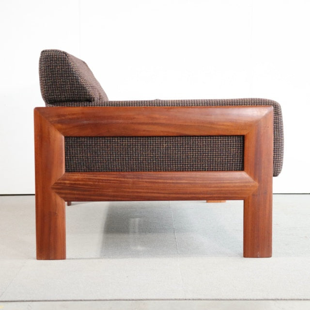 Vintage teak two-seater sofa with rich wood grain, British mid-century design, and brown textured Harris Tweed upholstery.