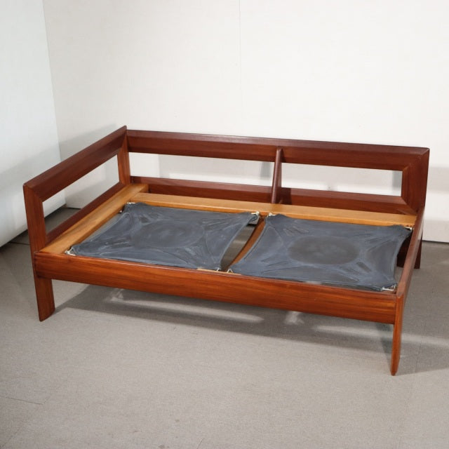 Vintage mid-century teak sofa frame with clean lines, angled legs, and open rectangular backrest from British-Denmark design.