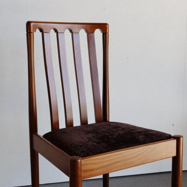Mid-century British Meredew teak dining chair with vertical slat back and dark upholstered seat cushion.