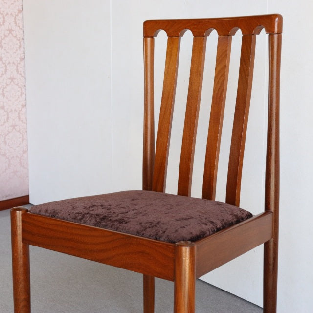 Vintage Meredew teak dining chair with mid-century British design, vertical slat back, and brown cushioned seat.