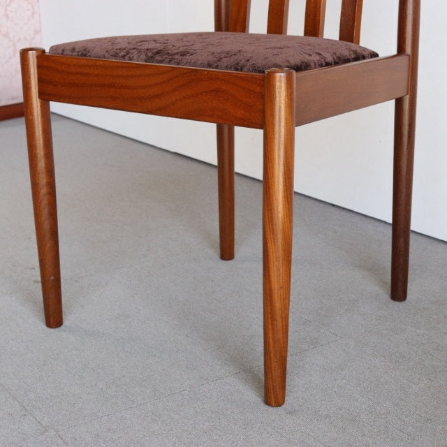 Mid-century Meredew vintage teak dining chair from Britain with tapered legs and cushioned seat upholstered in dark fabric.