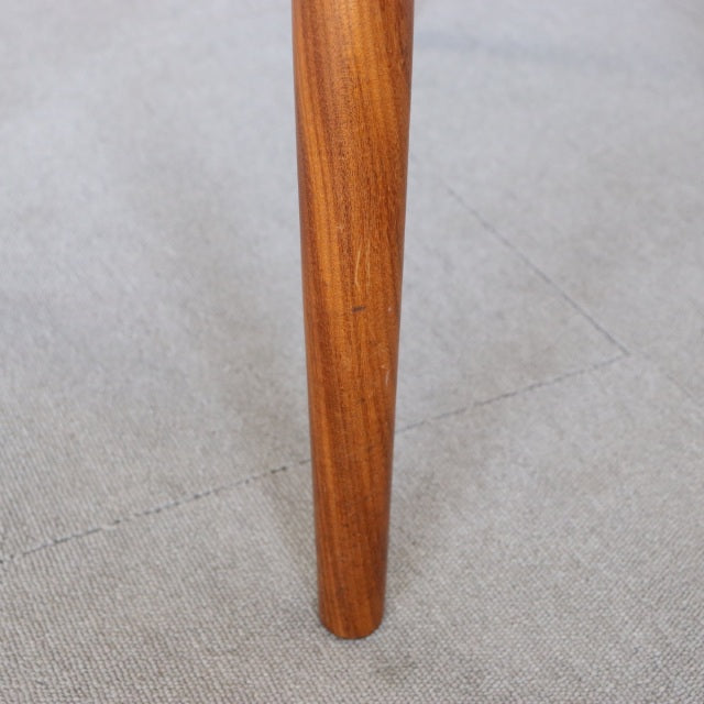Close-up of vintage teak leg from Meredew British mid-century dining chair with visible wood grain and smooth finish.