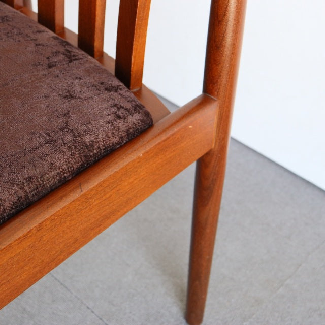 Vintage British Meredew teak dining chair leg and frame with smooth wood grain and dark textured fabric seat cushion,.