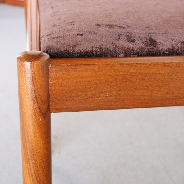 Close-up of vintage Meredew teak dining chair corner with mid-century British design and brown upholstered seat showing wood .