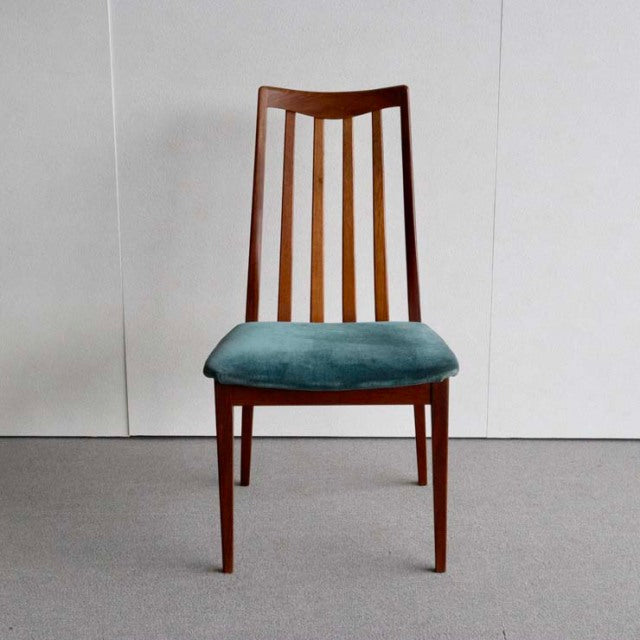 Mid-century British G-Plan dining chair with teak frame, vertical slat backrest, and teal upholstered seat.