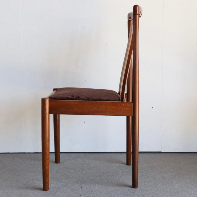 Mid-century British Meredew teak dining chair with brown upholstered seat and slender tapered legs.