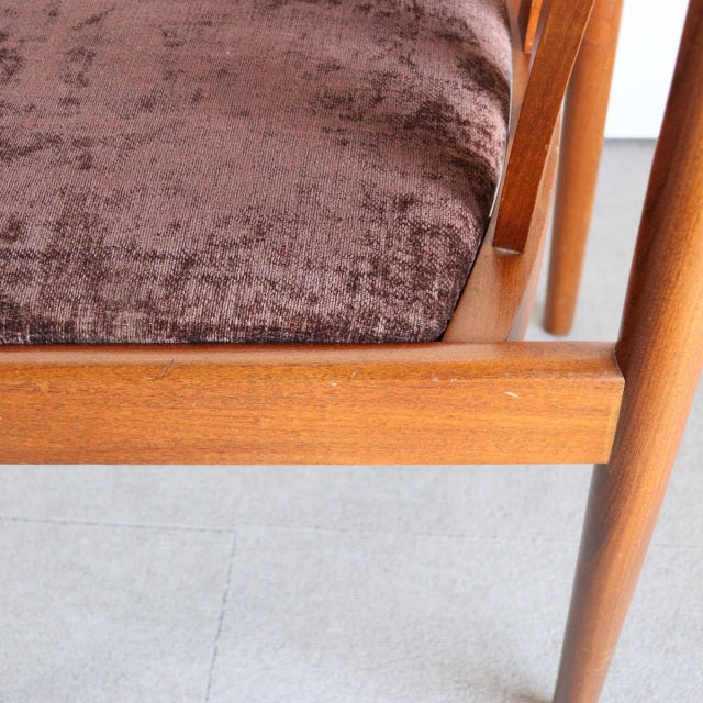 Mid-century British Meredew dining chair in vintage teak with rich wood grain and tapered legs, plush brown seat cushion.