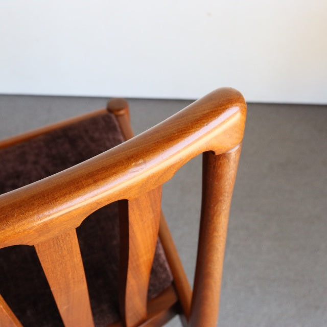 Vintage Meredew mid-century teak dining chair backrest with smooth rounded top rail and visible wood grain.