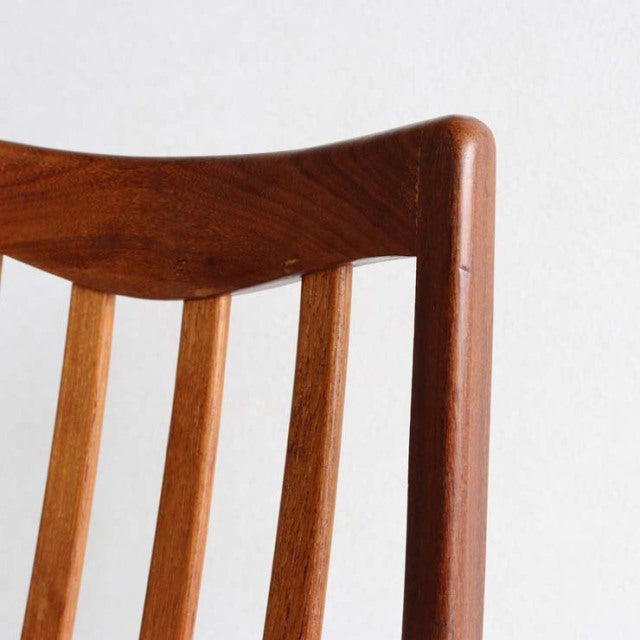 Mid-century British vintage G-PLAN chair with teak wood frame, smooth curved backrest, and vertical slats showing rich wood.