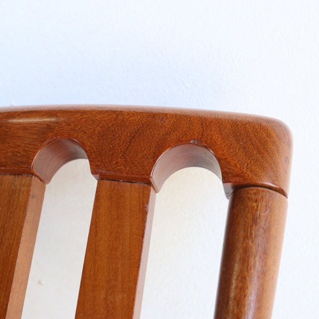 Close-up of vintage teak mid-century Meredew dining chair backrest with smooth rounded edges and visible wood grain.