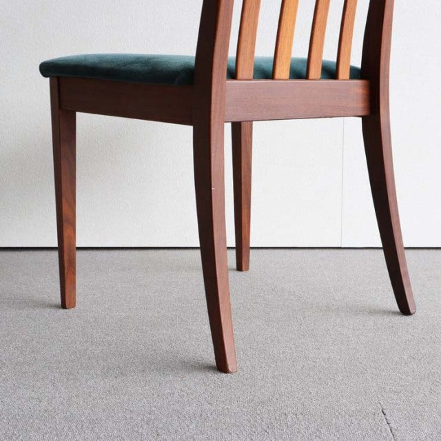 Vintage teak G-Plan chair with mid-century British design, curved backrest, and wood grain legs.