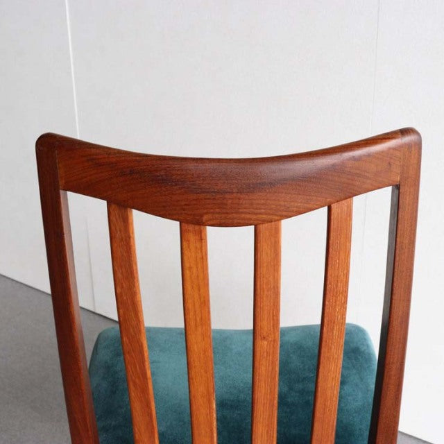 Vintage mid-century British G-Plan dining chair with teak frame and teal upholstered seat, vertical slat backrest, tapered.