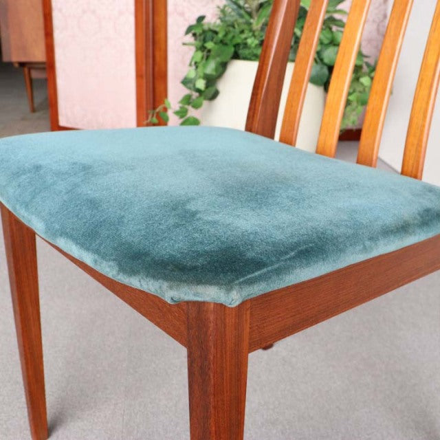 Mid-century British G-PLAN chair with teak frame and soft teal upholstered vintage seat, featuring wood grain legs and.