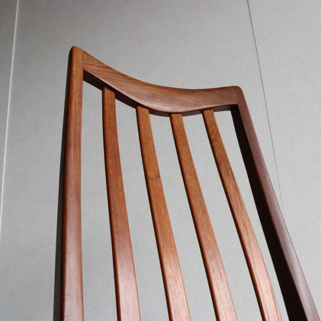 Mid-century British G-Plan dining chair in teak with vintage curved slatted backrest and visible wood grain.
